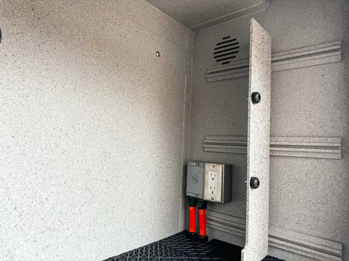 Deep corner compartment interior close-up showing wiring and liner texture.